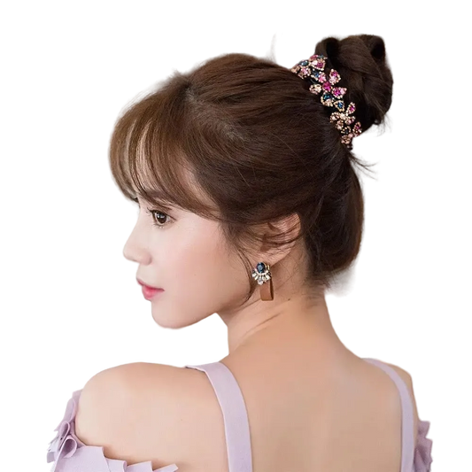 A woman shown from the back and side profile wearing a decorative hair accessory in a bun, with an earring visible. The hair accessory is a jeweled hair clip or hairpiece in pink, blue, and green tones.
