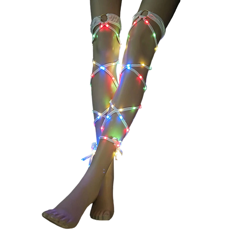 Legs wearing LED light-up leg straps on a black background