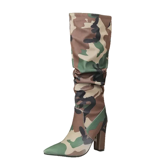 A single tall knee-high boot with a camouflage pattern in green, brown, beige, and black, featuring a pointed toe and a chunky block heel. The boot is shown on a plain white background
