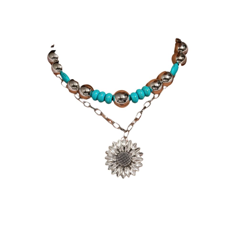 Necklace with turquoise beads and sunflower pendant on a white shirt