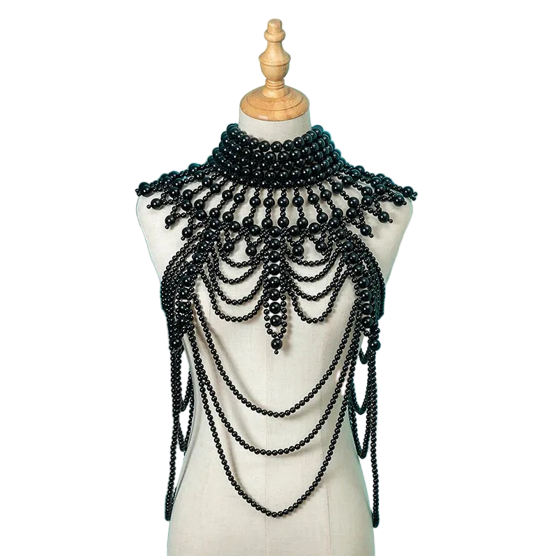 Black beaded necklace on a mannequin against a teal background