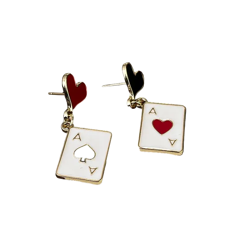 Pair of card-themed earrings on a wooden surface
