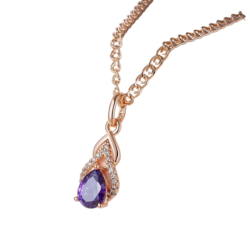Rose gold necklace with a purple teardrop pendant on a white stand.