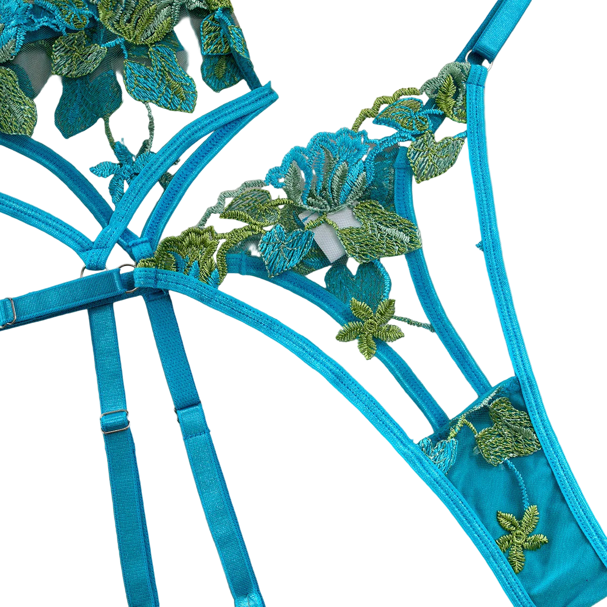 Blue lingerie set with green floral embroidery on a beige background