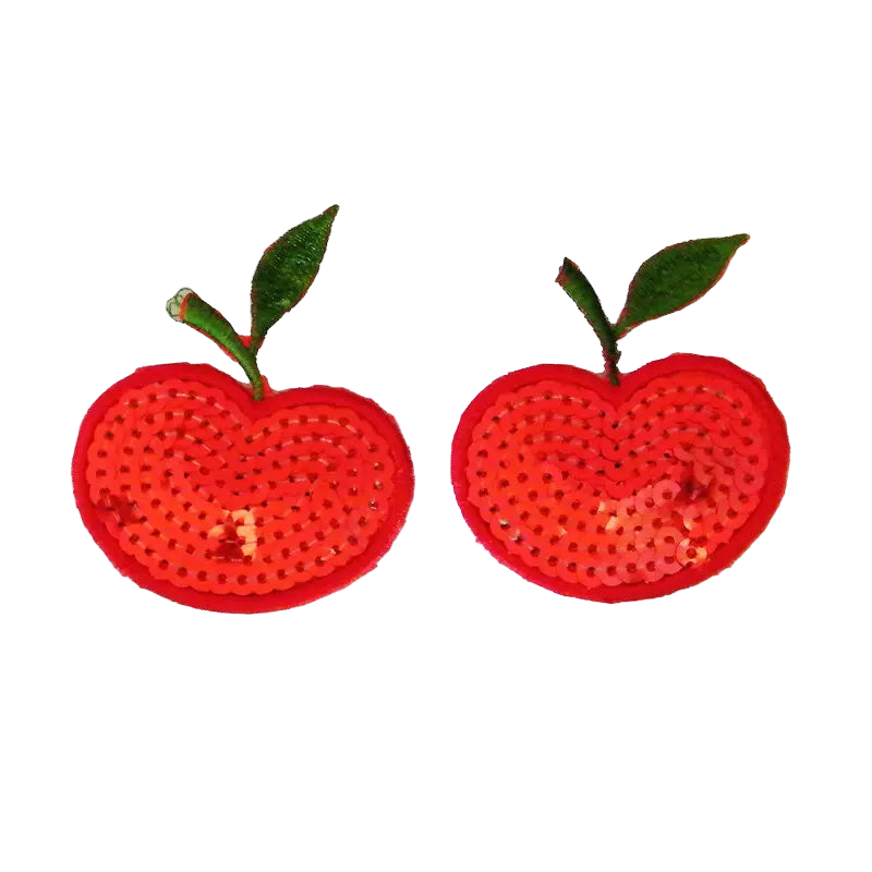 Pair of red apple-shaped earrings with green stems on a white background