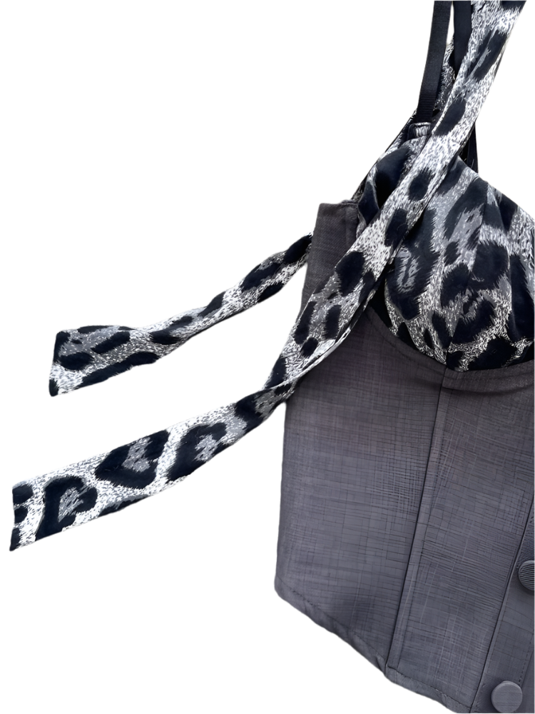 Gray coat with a leopard print scarf on a textured surface