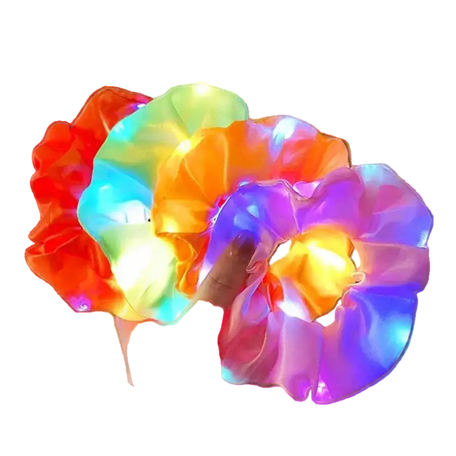 Colorful LED scrunchies being held in a hand with a blurred outdoor background