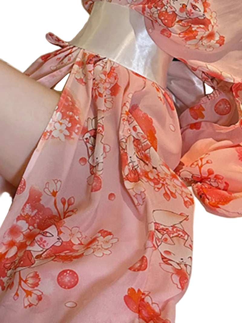 Close-up of a floral dress with pink and orange flowers on a white background