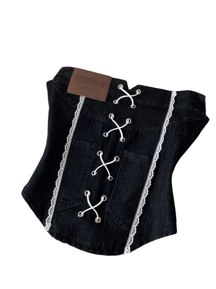 Black denim vest with lace details on a white surface