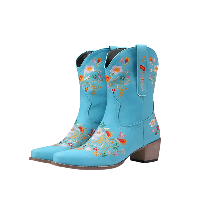 Pair of blue cowboy boots with floral embroidery on a white background