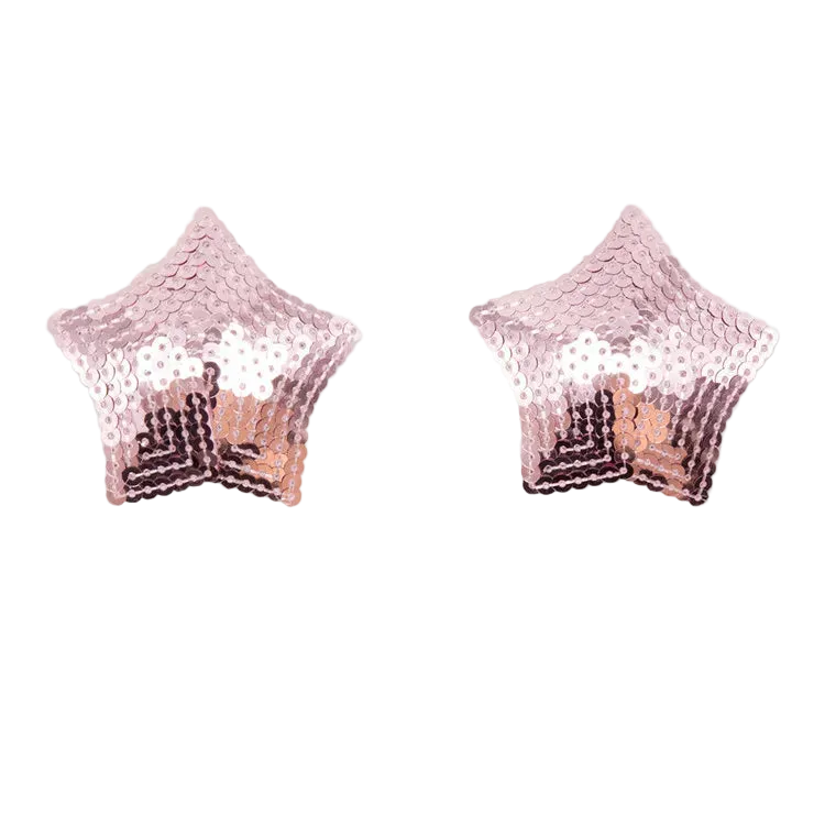 A pair of star-shaped stud earrings covered in rose gold sequins, displayed on a clean white background with a soft reflection underneath.