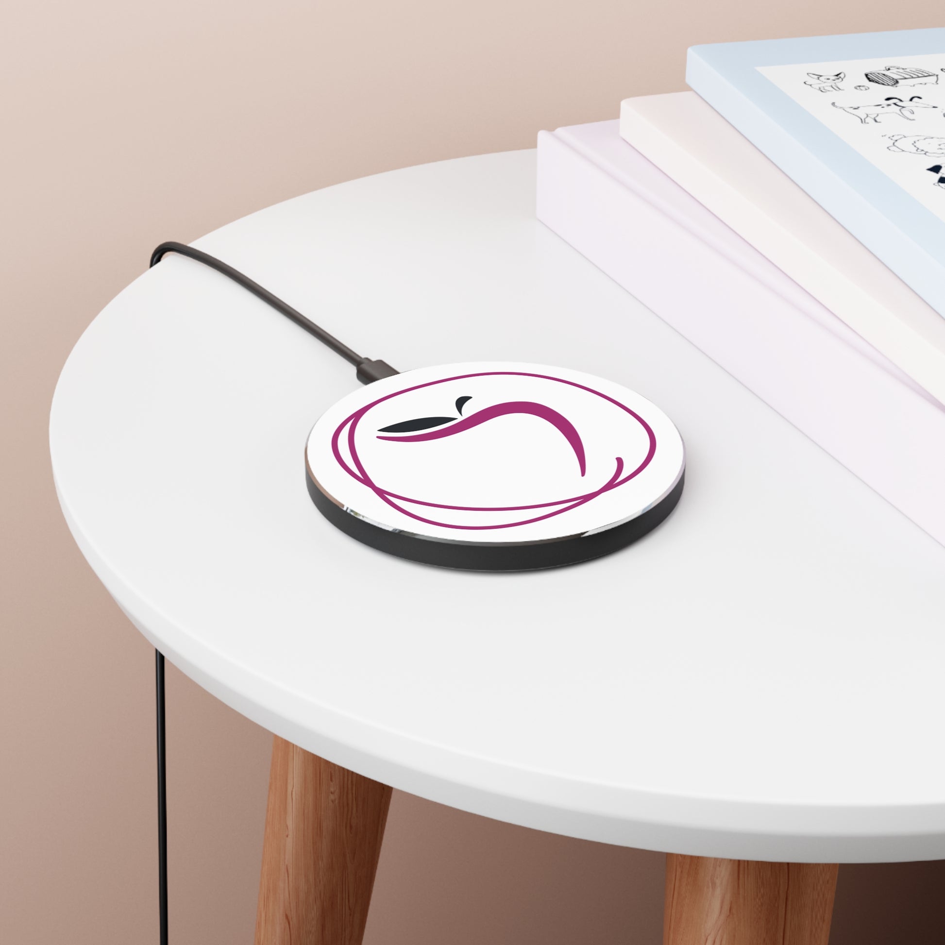 Round white device with purple design on a white table