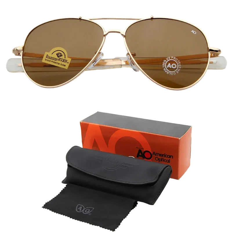 AO aviator sunglasses with brown lenses and a gold-tone metal frame, shown above their orange and black retail box, black hard case, and black microfiber cleaning cloth on a white background.