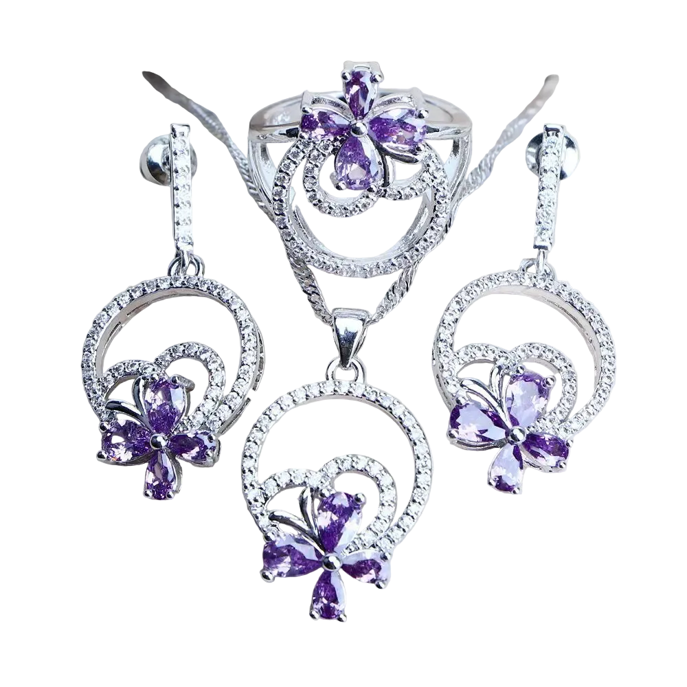 Silver jewelry set with purple gemstones on a light background