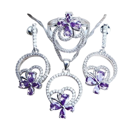 Silver jewelry set with purple gemstones on a light background