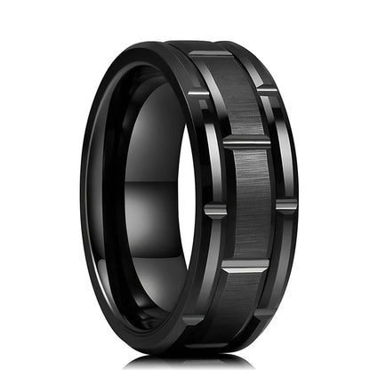 Close-up of the black tungsten ring, highlighting the intricate brick pattern and polished beveled edges.