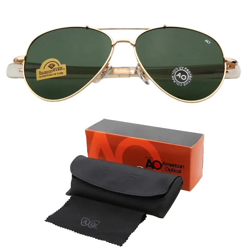Gold-framed aviator sunglasses with dark green lenses, shown above their orange and black AO American Optical box, black case, and black microfiber cloth on a white background.