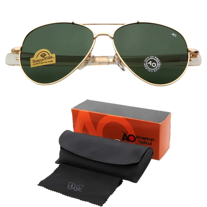 Gold-framed aviator sunglasses with dark green lenses, shown above their orange and black AO American Optical box, black case, and black microfiber cloth on a white background.