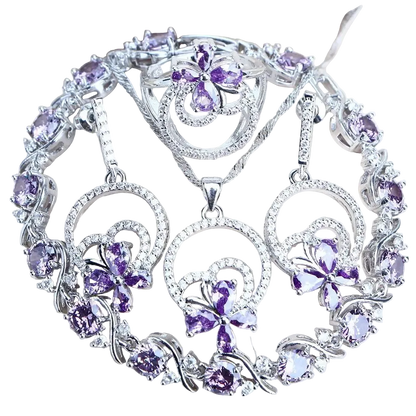 Silver necklace with purple gemstone pendants on a white background