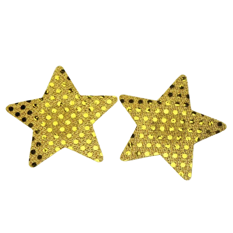 Two gold glitter star-shaped accessories with black polka dots, displayed on a white background