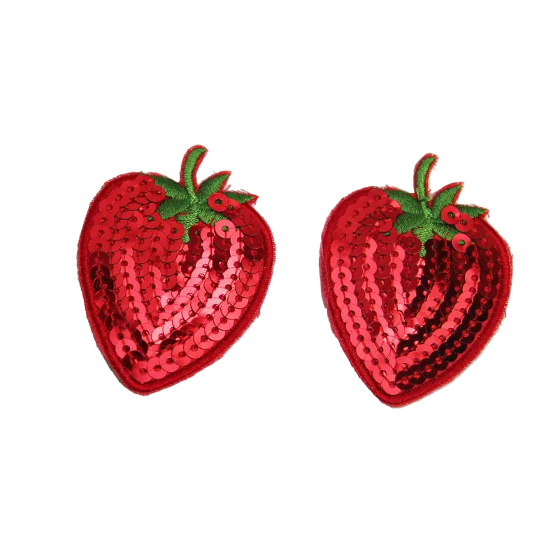 Two red sequin strawberry patches on a white background