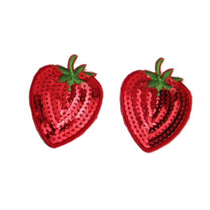 Two red sequin strawberry patches on a white background