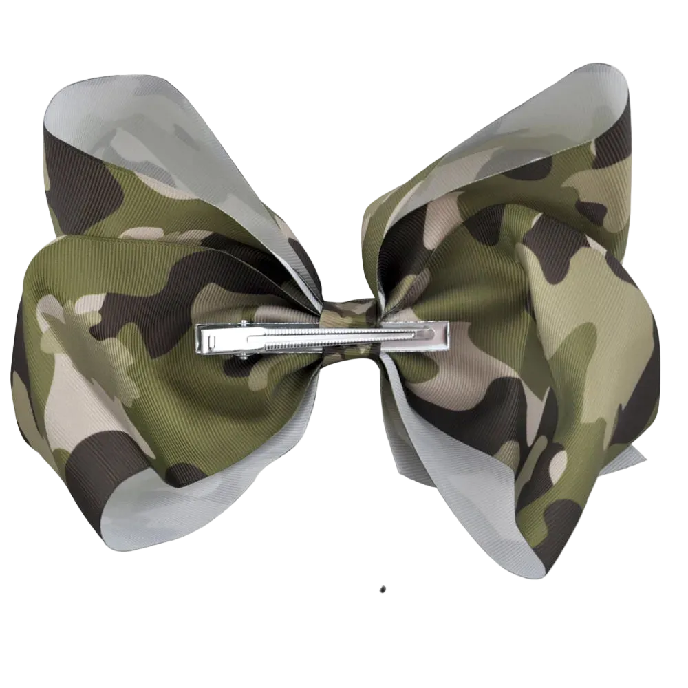 A camouflage-patterned hair bow with a silver metal clip, shown against a white background with an '8 Inch' size measurement line and text below.