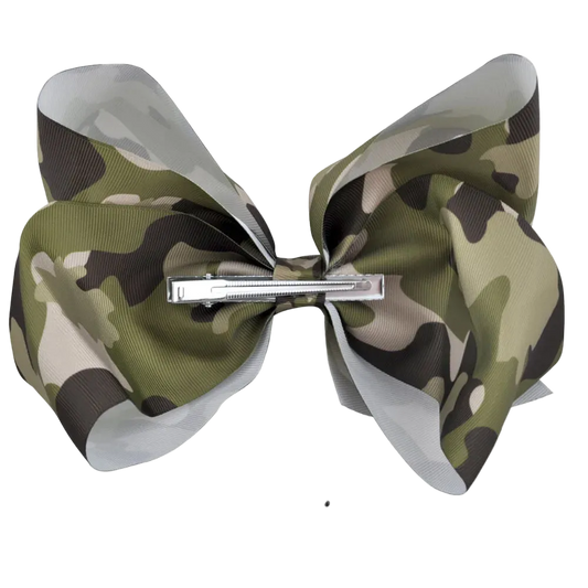 A camouflage-patterned hair bow with a silver metal clip, shown against a white background with an '8 Inch' size measurement line and text below.