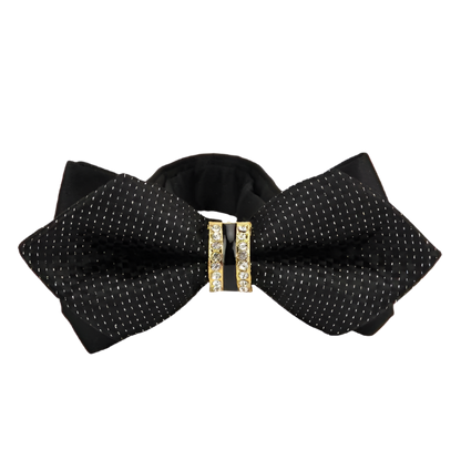 Black bow tie with gold embellishments on a white background