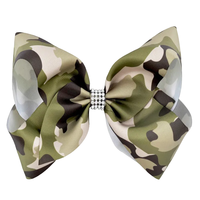 A large bow tie with an olive green, beige, and black camouflage pattern, featuring a small rhinestone-embellished center band, shown on a plain white background.