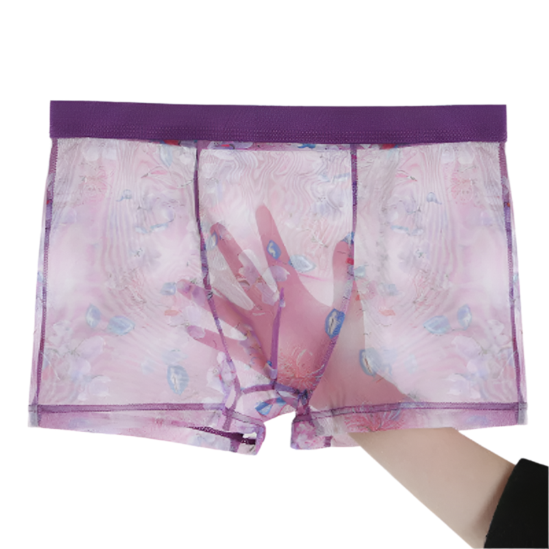 Pink mesh boxer briefs with purple waistband held by a hand on a white background
