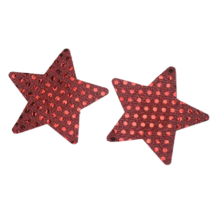 Two red star-shaped stud earrings with a black sequin background and pink polka dots, shown on a white