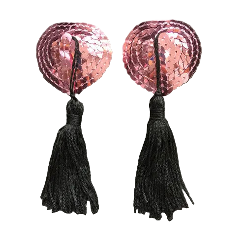 Pair of pink sequin heart-shaped earrings with black tassels on a gray background