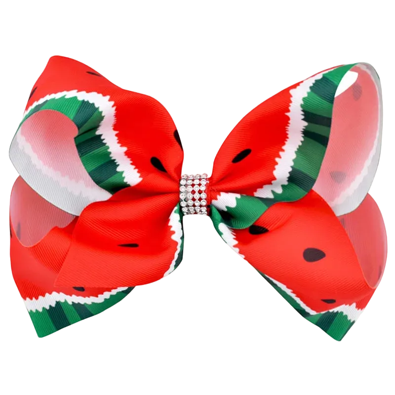 A large hair bow featuring a watermelon print with red, green, white, and black patterns, secured in the center with a rhinestone-embellished band, shown on a plain white background.