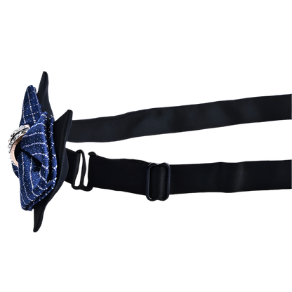 Black belt with a blue floral accessory on a white background