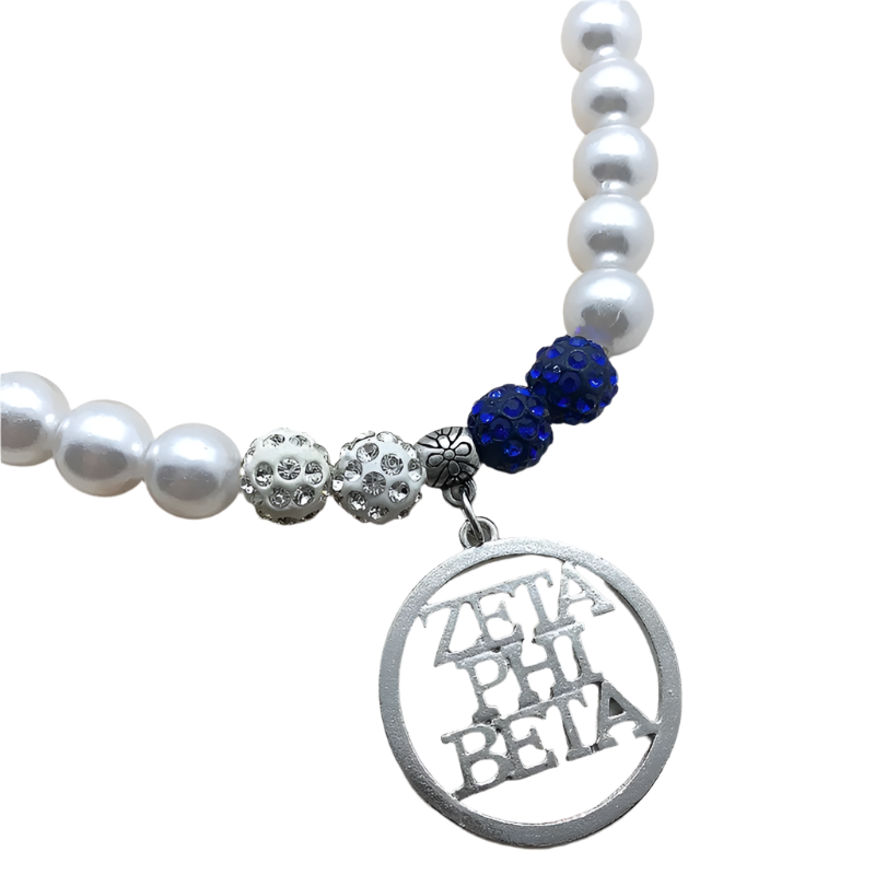 Pearl necklace with blue beads and a 'Zeta Phi Beta' charm on a wooden surface