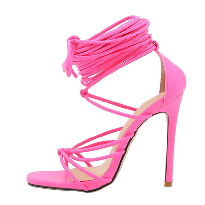 Pink high-heeled sandal with strappy design on a white background