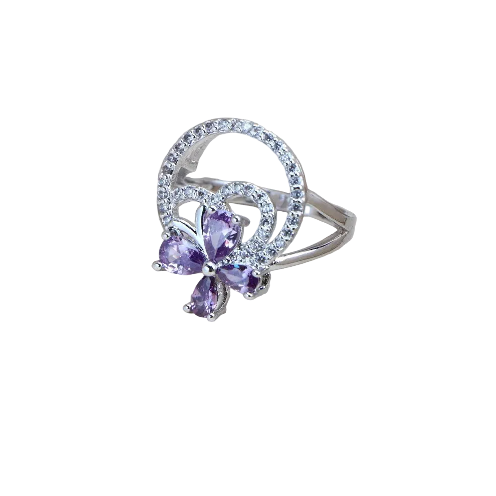 Silver ring with purple gemstones on a light background