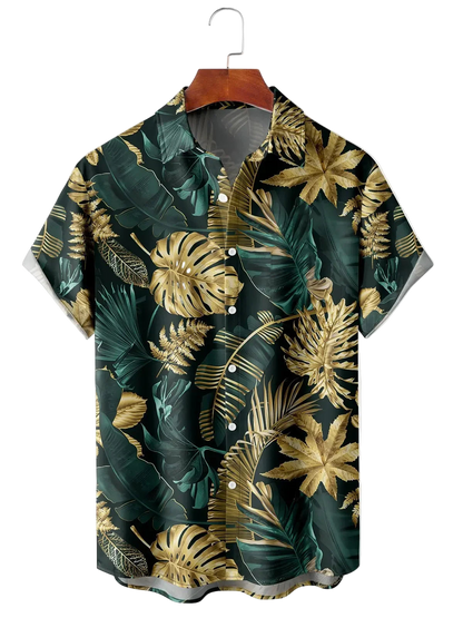 Hawaiian shirt with gold and green leaf pattern on a hanger against a white background