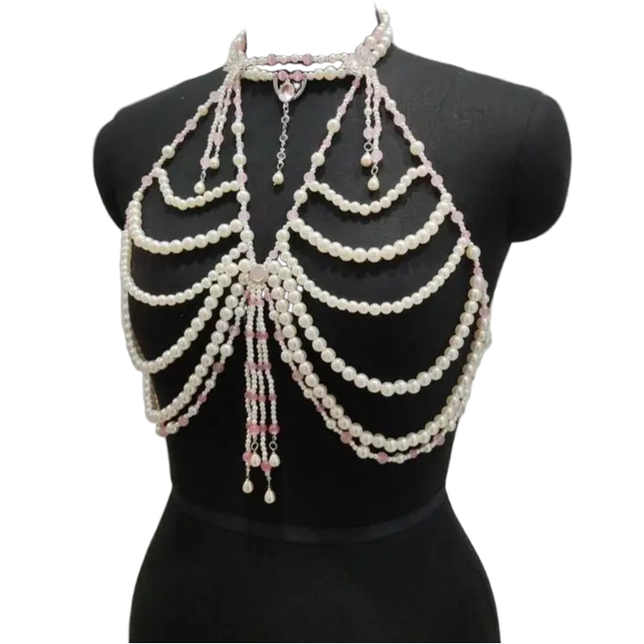 Pearl-based body chain on a mannequin against a gray background