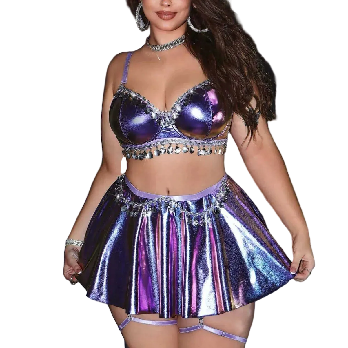 Person wearing a shiny purple outfit with a metallic skirt and top against a silver curtain background.