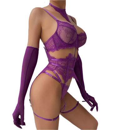 Person wearing a purple lace lingerie set with matching gloves against a white wall.