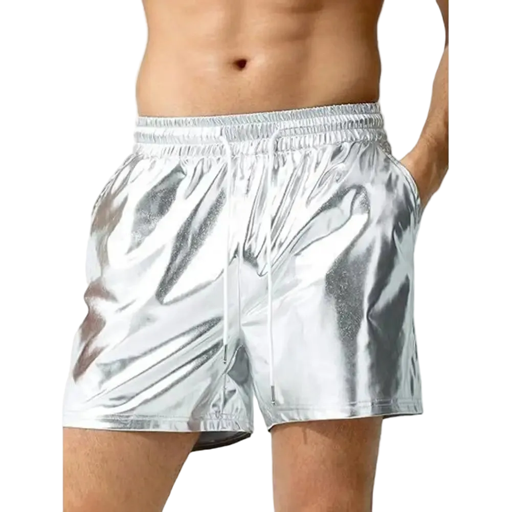 A person wearing shiny metallic silver shorts against a plain white background.
