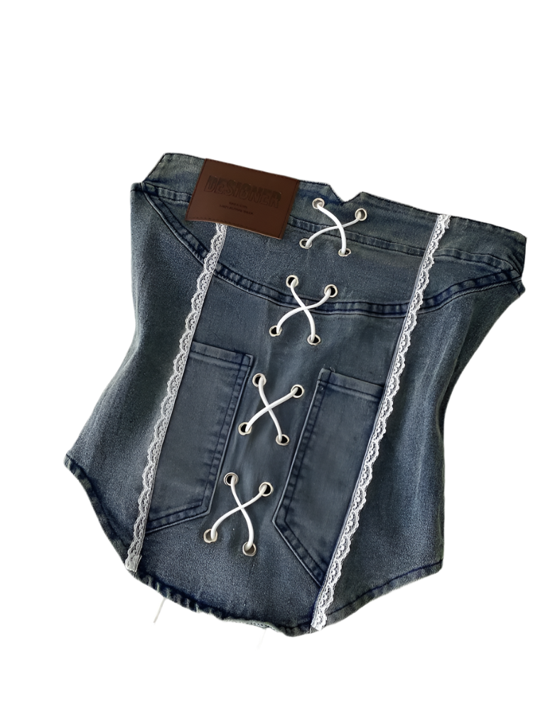 Denim pet corset with lace details on a white surface