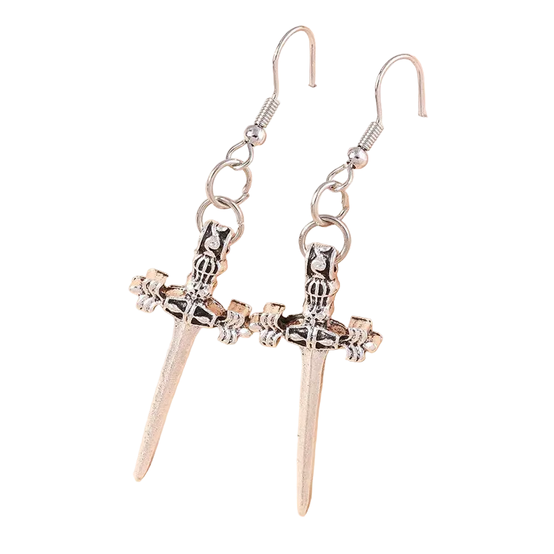 Silver sword-shaped earrings on a beige background