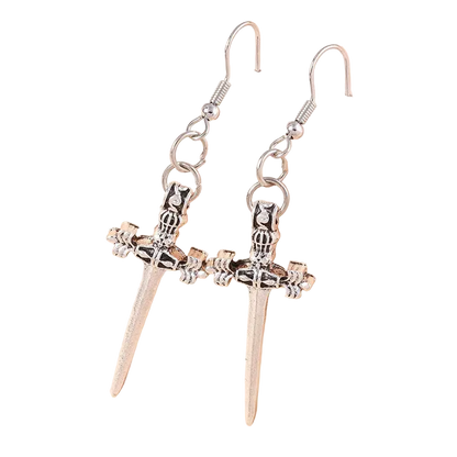 Silver sword-shaped earrings on a beige background