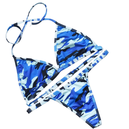 Blue and white camouflage bikini set on a gray surface with decorative elements.