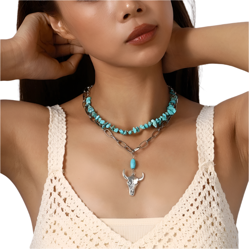 Woman wearing a turquoise necklace with a bull head pendant against a neutral background