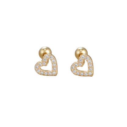 Heart-shaped gold earrings with clear stones on a beige background