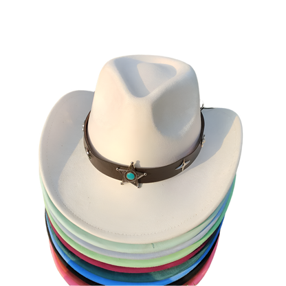 Stack of colorful cowboy hats with a white top hat on grass